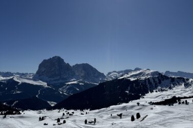 Skiing with Langkofel and Plattkofel mountains in the background